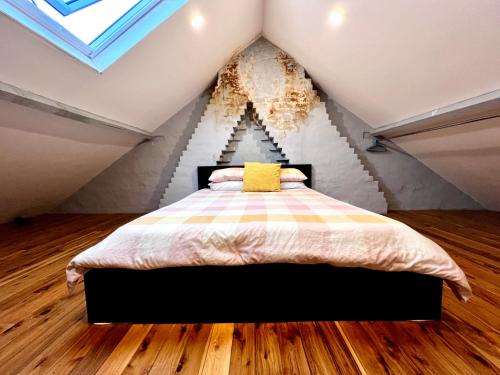 a bedroom with a bed in a attic at Coco’s Abode in Sydney