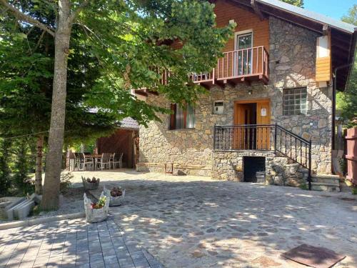 a stone house with a balcony and a patio at Villa Albani in Peje