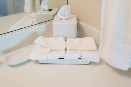 a pile of towels on a bathroom counter in front of a mirror at Gorgeous Napa Valley Getaway - Steps from Wineries in Napa