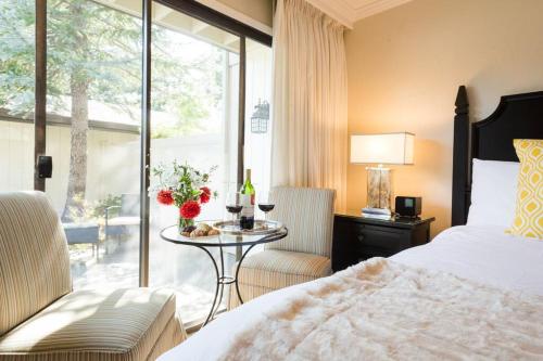 a bedroom with a bed and a table and a window at Gorgeous Napa Valley Getaway - Steps from Wineries in Napa