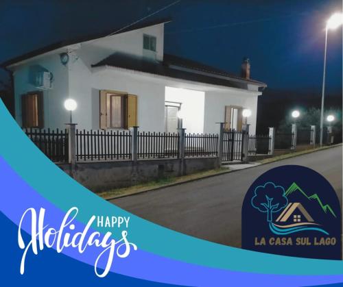 a house at night with the words happy holidays at la casa sul lago in Scafa