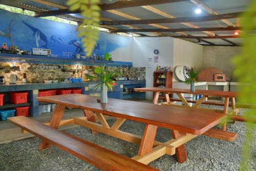 three picnic tables in a restaurant with a counter at Hotel Swell Pavones in Pavones