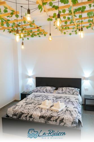 a bedroom with a bed with two books on it at La Riviera in Scalea