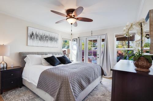 a bedroom with a bed with a ceiling fan at Relax in a Gorgeous 6 Person Quaint Home in San Jose