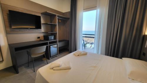 Postel nebo postele na pokoji v ubytování Hotel Giannini