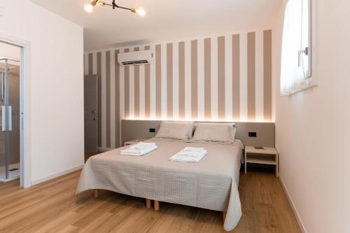 a bedroom with a bed with two towels on it at TommyHouse in Borso del Grappa