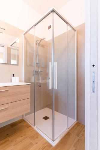 a glass shower in a bathroom with a sink at TommyHouse in Borso del Grappa