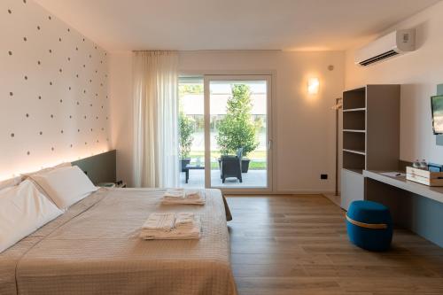 a bedroom with a large bed and a large window at TommyHouse in Borso del Grappa