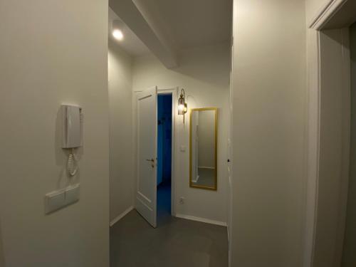 un pasillo con una puerta azul y un espejo en Comfort Garden View Apartment, en Cracovia