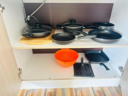 a shelf with many pots and pans on it at Departamento amoblado calama in Calama