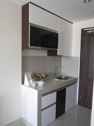 a small kitchen with a sink and a microwave at Otel Hotel in Sentool