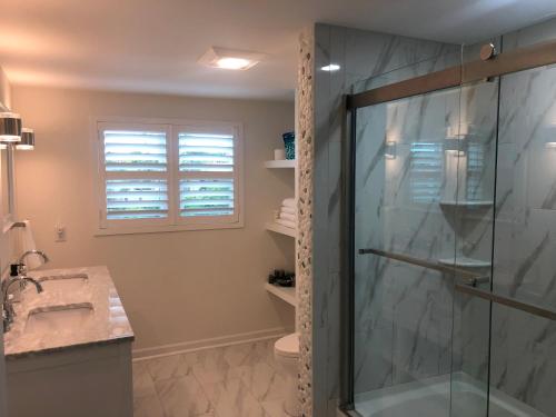 a bathroom with a shower and a sink at Auberge d'Amelia in Fernandina Beach