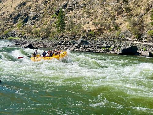 a group of people in a raft in a river at Steelhead Lodge in Lucile