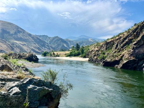 a river in a canyon with mountains in the background at Steelhead Lodge in Lucile