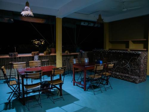 a room with a table and chairs and a bar at Kep Villa Hill Guest House 1 in Kep