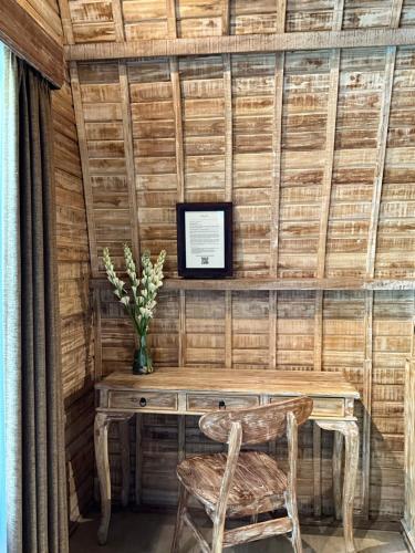 a room with a wooden table and a chair at Tanhana Villa Canggu in Canggu
