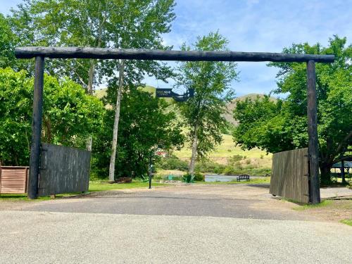 an entrance to a park with a wooden gate at Steelhead Lodge in Lucile