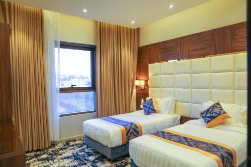Postel nebo postele na pokoji v ubytování Oriens Hotel