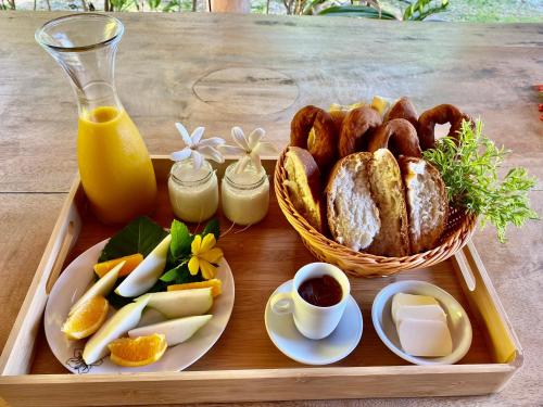 a tray of food with bread and a basket of food at Poe Guesthouse in Avatoru