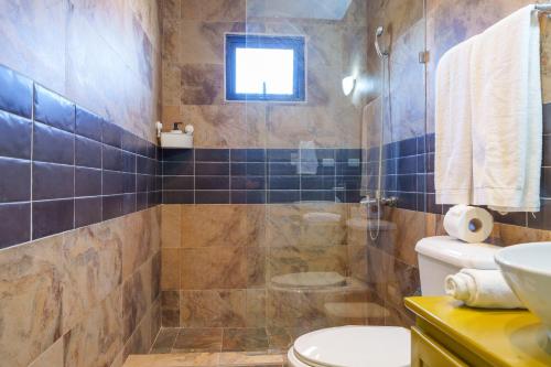 a bathroom with a shower and a toilet and a sink at Beautiful Three Storage House Near Playa Caleta in La Romana