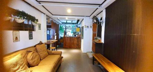 a living room with a couch and a table at Kalis Viewpoint Lodge Coron in Coron