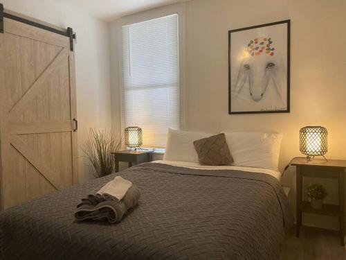 a bedroom with a bed with a white goat on the wall at Chic Bungalow Apartment steps from Armature Works & Downtown Riverwalk in Tampa
