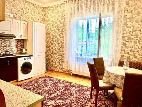 a kitchen with a table and a window in a room at Golden Villa in Daşca