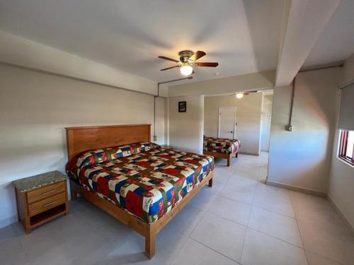 a bedroom with a bed and a ceiling fan at HOTEL VILLAGRAN in Tijuana