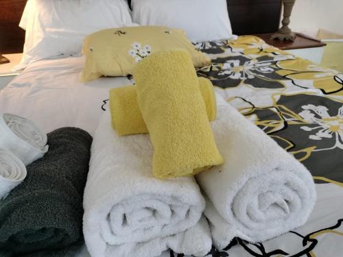 a pile of towels sitting on top of a bed at Gorgeous ,stylish and Beautiful Luxury Apartment with stuning Downtown View.Featuring American and French style in Frederick