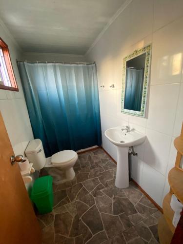 a bathroom with a toilet and a sink at Hospedaje Pudahuel in Santiago