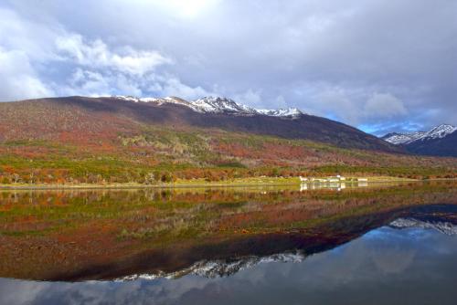 a reflection of a mountain in a body of water at Refugio El Cauque in Puerto Williams