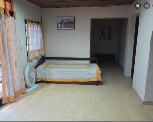 1 dormitorio con 1 cama en la esquina de una habitación en departamento Gorriti en San Salvador de Jujuy