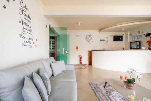 a living room with a couch and a table at Pousada Vista do Rio in Barreirinhas