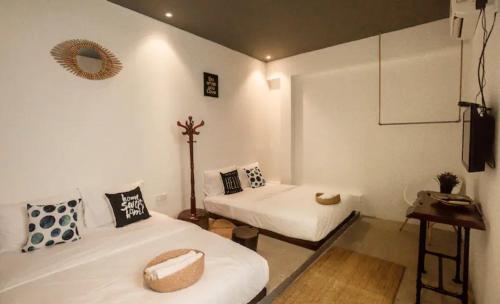 a room with two beds and a television in it at Amazing Home Inn in George Town