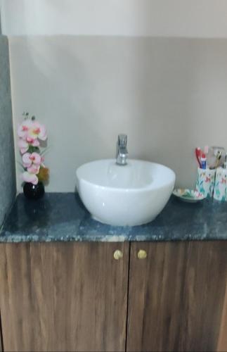 a white sink sitting on top of a counter at SERENITY - Apartment with Modern Amenities in Igatpuri