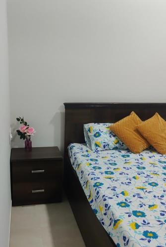 a bedroom with a bed and a night stand at SERENITY - Apartment with Modern Amenities in Igatpuri