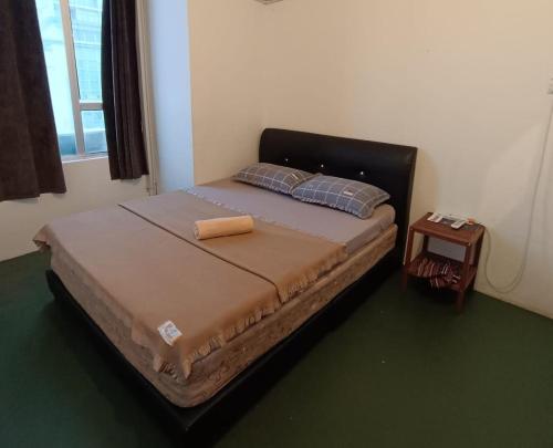a bedroom with a large bed with a pillow at Tabun Homestay in Miri