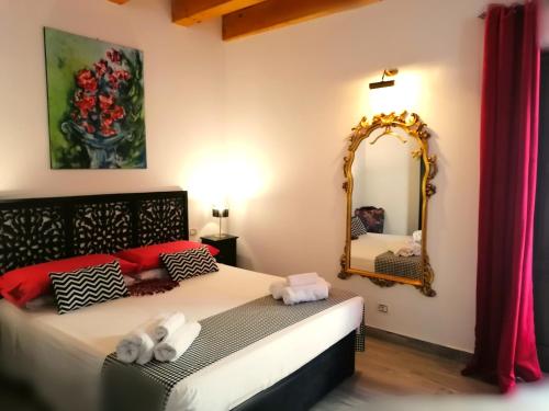 sypialnia z dużym lustrem i łóżkiem w obiekcie Casa Busari w mieście Palermo