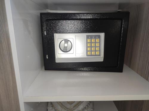 a microwave oven sitting on top of a shelf at Апартаменты у моря - в "Green City RESORT" in Baku