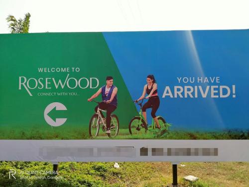 a billboard with a man and woman riding bikes at NASHVILLE - Apartment with Modern Amenities in Igatpuri