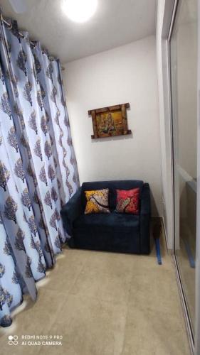 a living room with a couch in a room at NASHVILLE - Apartment with Modern Amenities in Igatpuri
