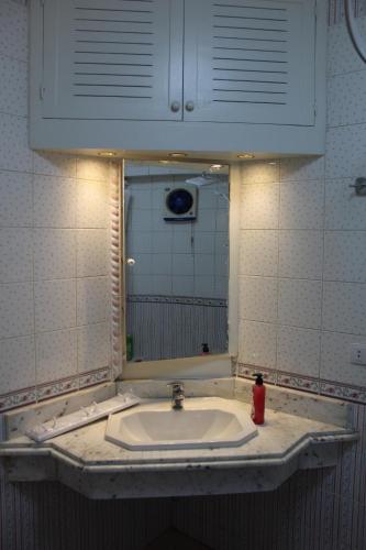 a bathroom with a sink and a mirror at Giza - Pyramids/Museum Apartment in Cairo