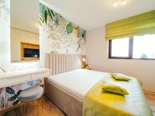 a bedroom with a large bed and a sink at RAINFOREST APARTAMENT in Ghimbav