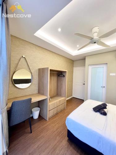 a bedroom with a bed and a desk and a mirror at Costa Mahkota Suites Malacca Central By Nestcove in Melaka