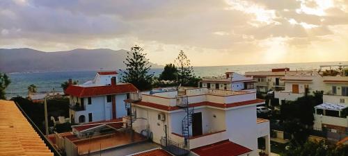 a group of buildings with the ocean in the background at Villemar in Isola delle Femmine