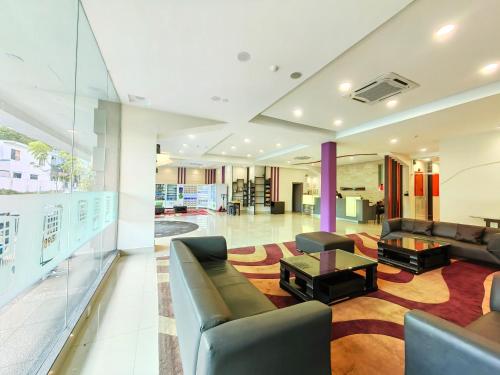 a large living room with couches and a table at Hotel 98 in Kuching