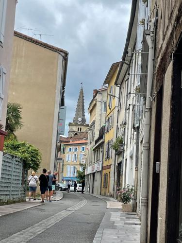 a group of people walking down a street with buildings at " Loutrein Lodge " Hyper Centre - Calme - WiFi in Saint-Girons