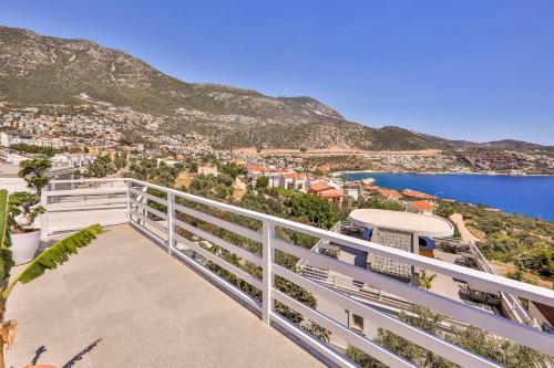 a balcony with a view of a city and the ocean at Kalkan Saray Suites Hotel in Kalkan