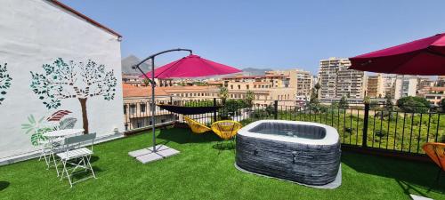 a balcony with a hot tub and a table and chairs at I Sollazzi in Palermo