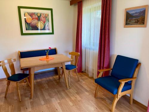a dining room with a table and two chairs at Lindenhof Inzell - FeWo mit Chiemgaukarte in Inzell